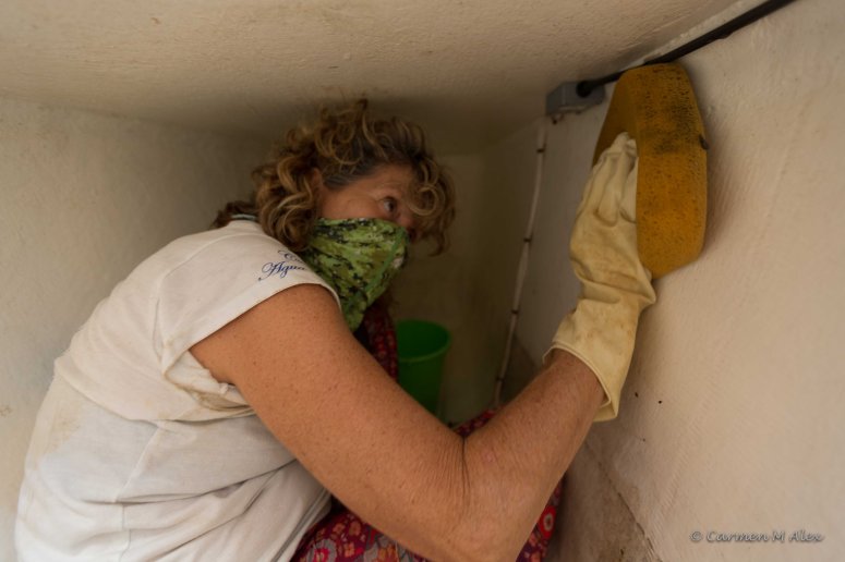Photo of Gail cleaning the inside of the forward port hull.