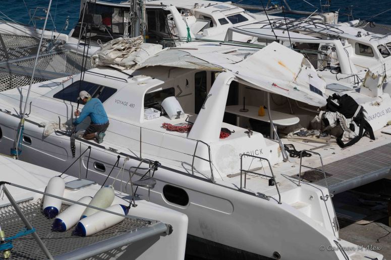 Photo of Steve on catamaran, working on rigging.
